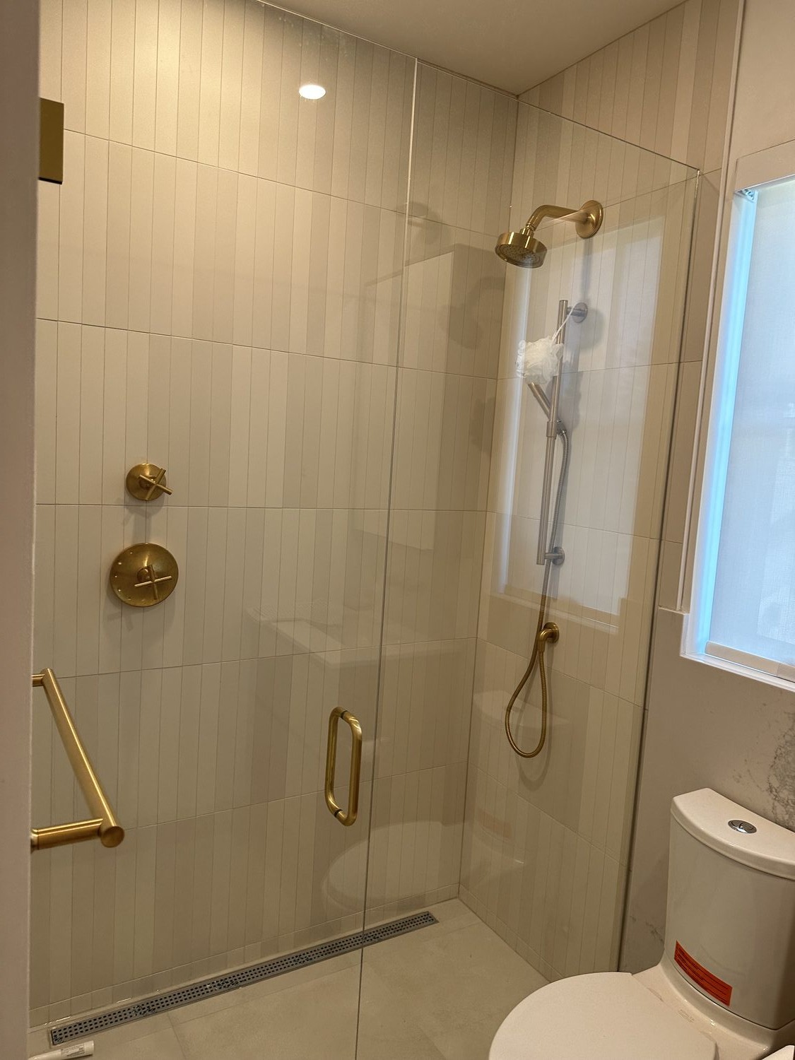 Bathroom shower with brass fixtures