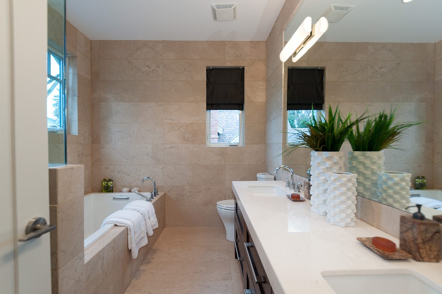 Bathroom with marble tile and soaker tub
