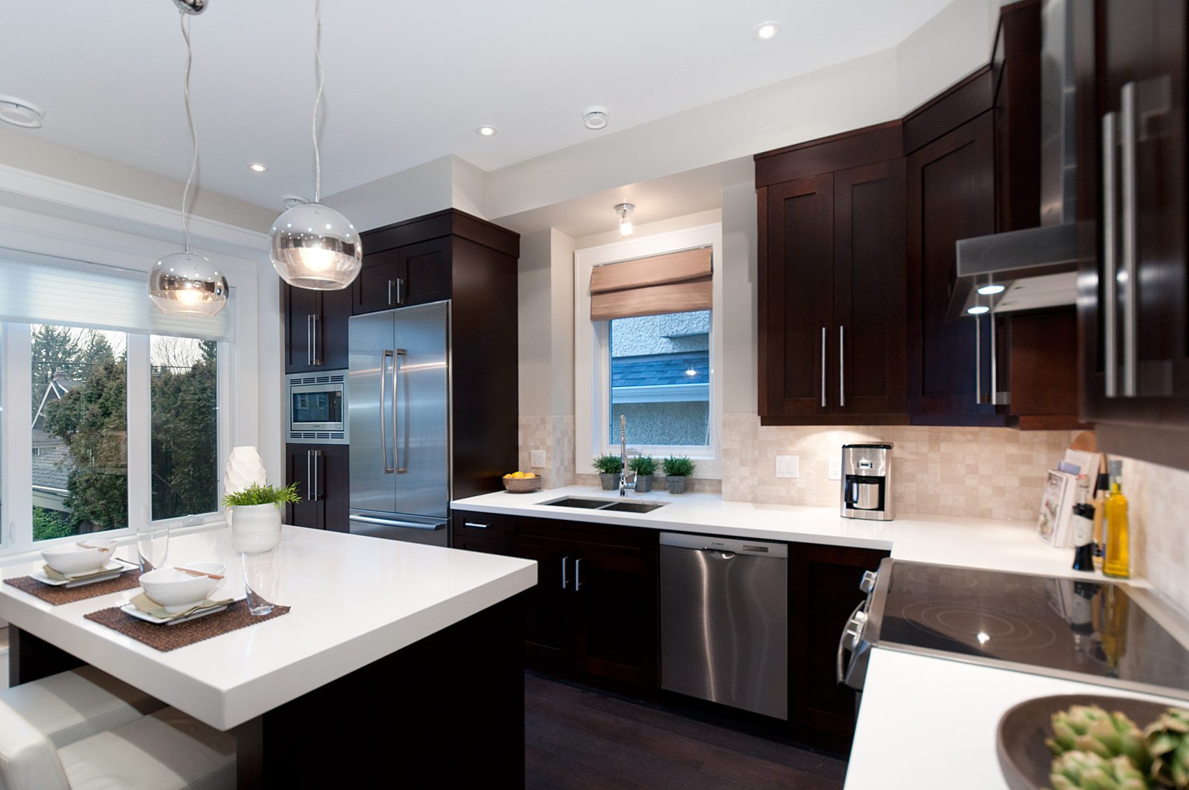 Kitchen with dark cabinetry and stainless appliances