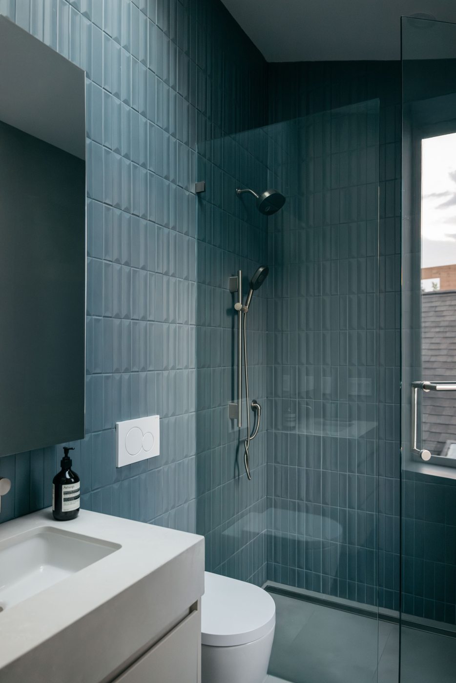 Bathroom with blue tile shower