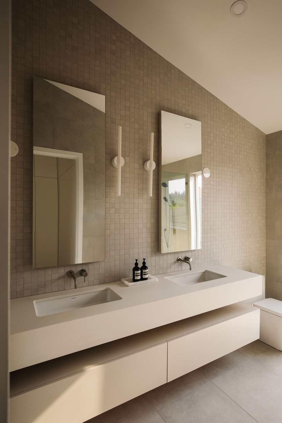 Bathroom with double vanity and mosaic tile wall