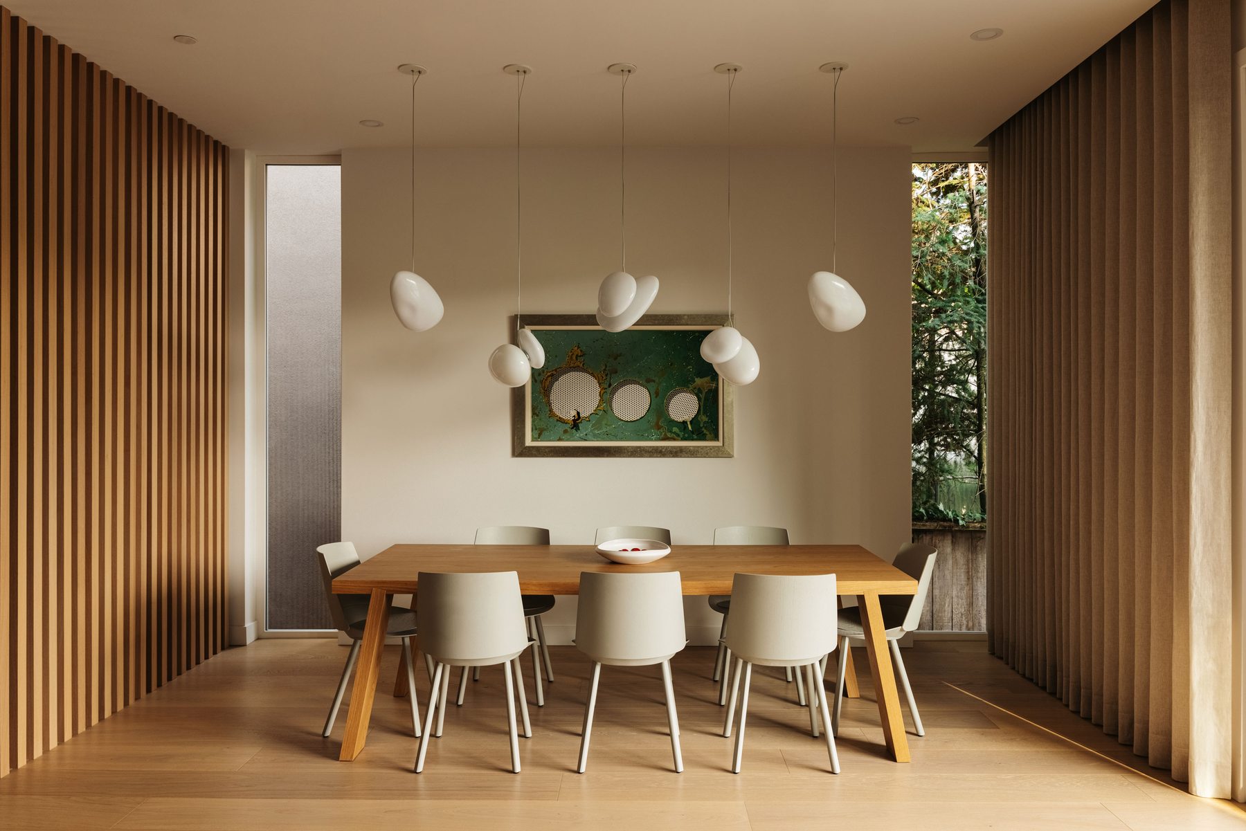 Dining room with sculptural pendant lighting