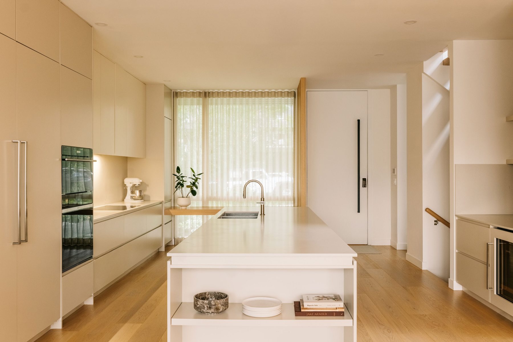 Kitchen island with view to entry and staircase