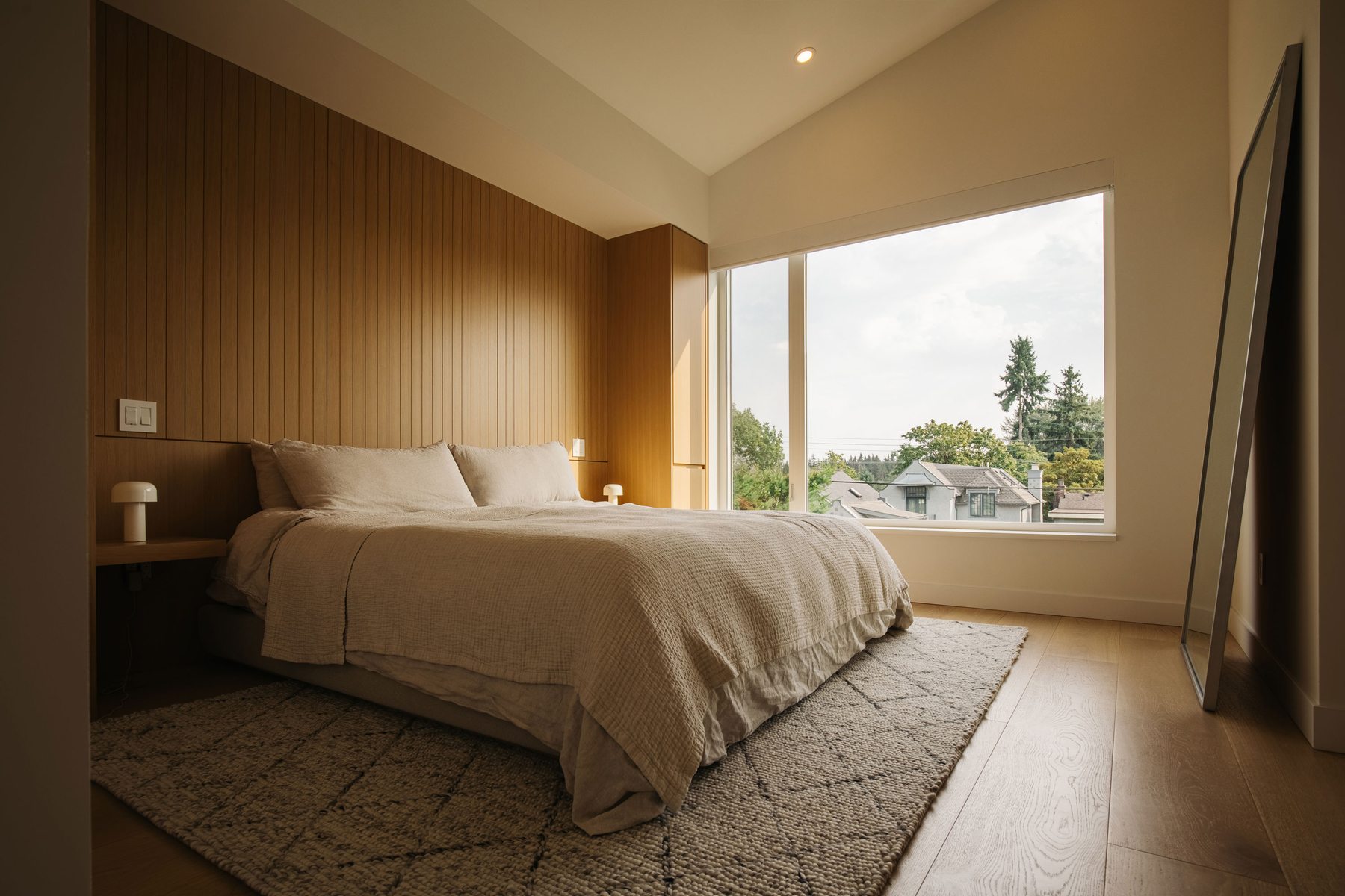 Primary bedroom with wood slat headwall