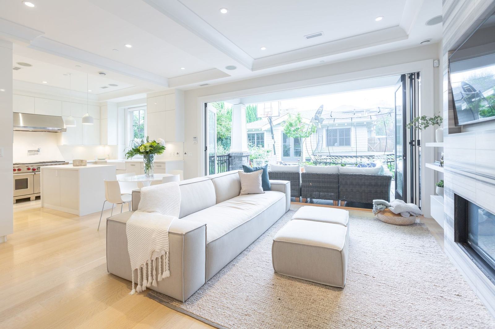 Open kitchen and living area with folding doors to the backyard